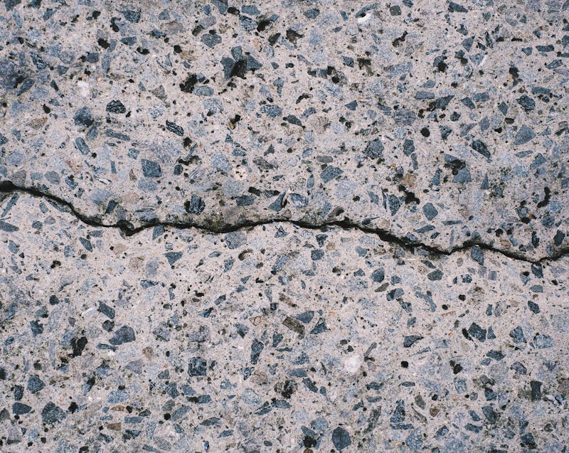 a crack on a textured concrete surface