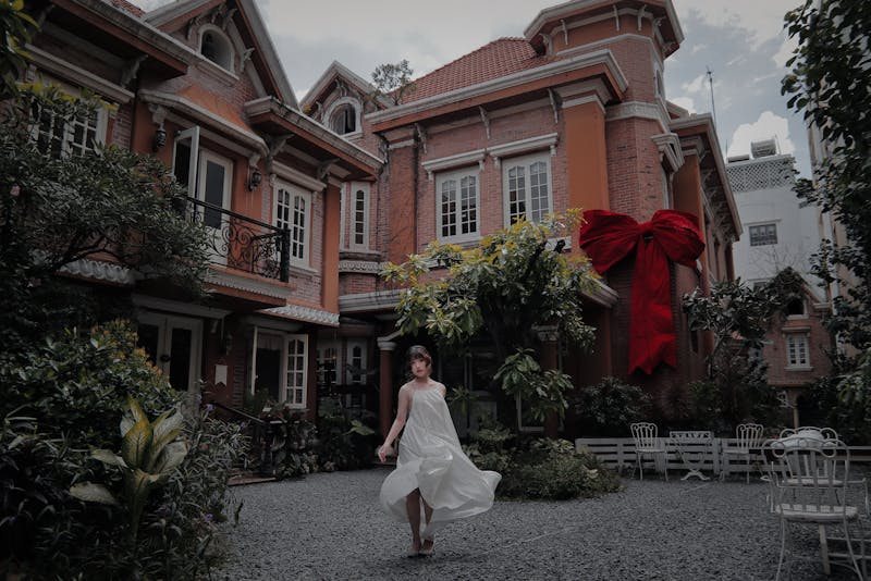 a woman in front of a house